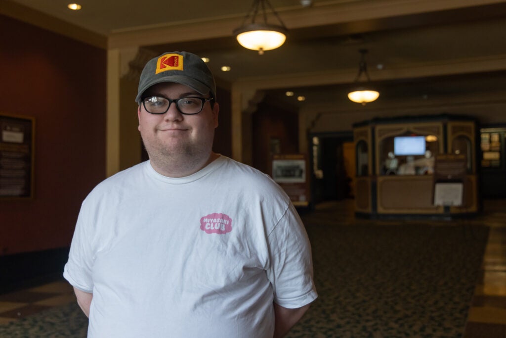 Grant Gow poses for a photo in the Ambler Theater
