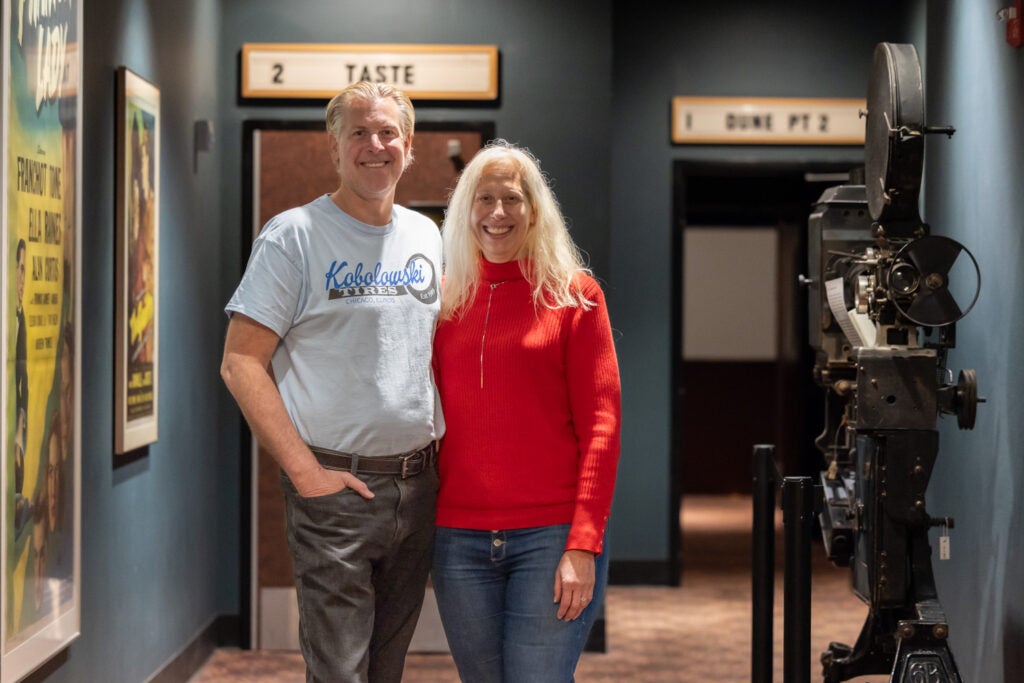 Jason Marcewicz (left) and Stacy Borans (right) pose for a photo at the movie theater