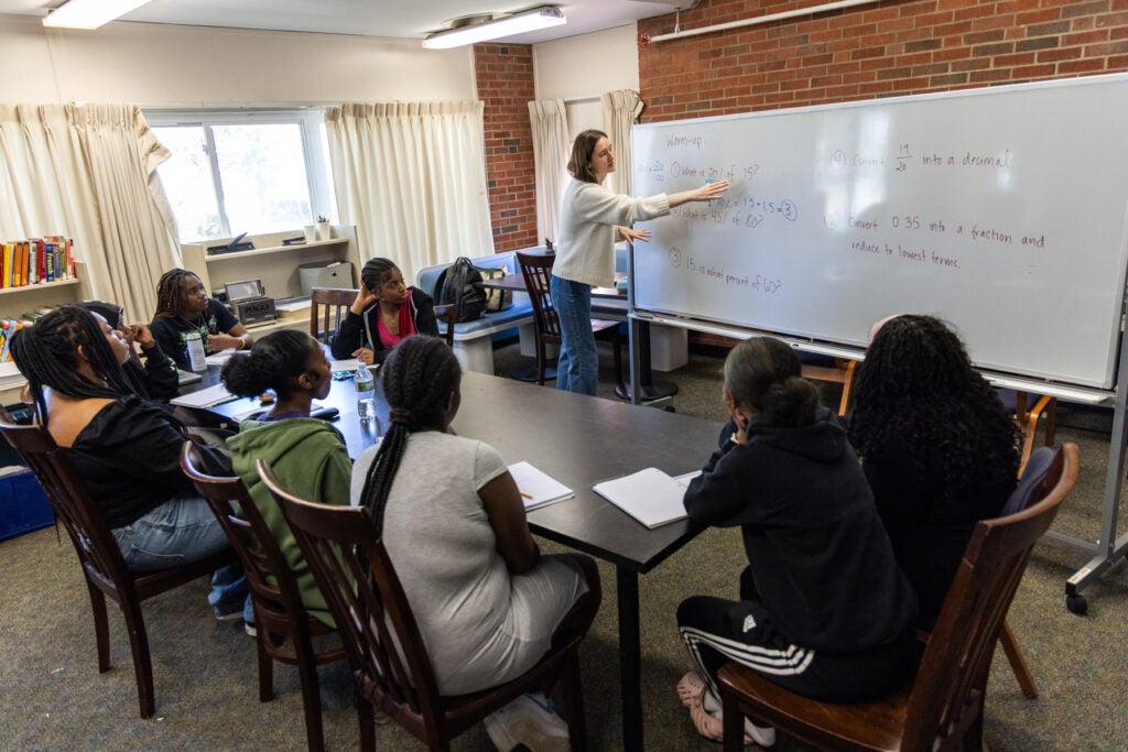 a tutor tutoring children in the HomeWorks Trenton program