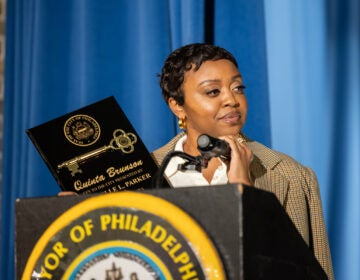 Quinta Brunson looks on from behind a podium