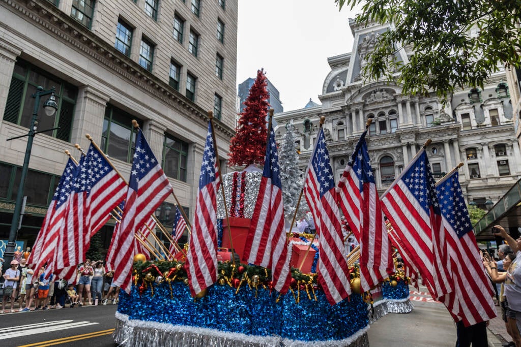 A Christmas in July-themed float featured Santa Claus at the Fourth of July Parade in Center City Philadelphia