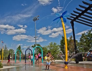 Elated children at Finley Recreation Center in Philadelphia run through the sprayground on the first day of operation, May 27, 2021. (Kimberly Paynter/WHYY)