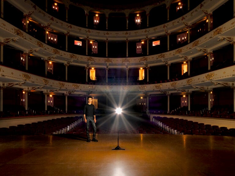 Anthony Roth Costanzo stands on the stage at the Academy of Music