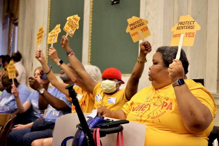 Members of OnePA Renters United Philadelphia hold signs reading SAFE HEALTHY HOMES and PROTECT RENTERS! VOTE YES