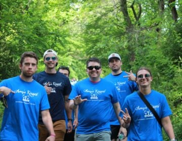 A group of people wearing 'Amy's Kisses' shirts