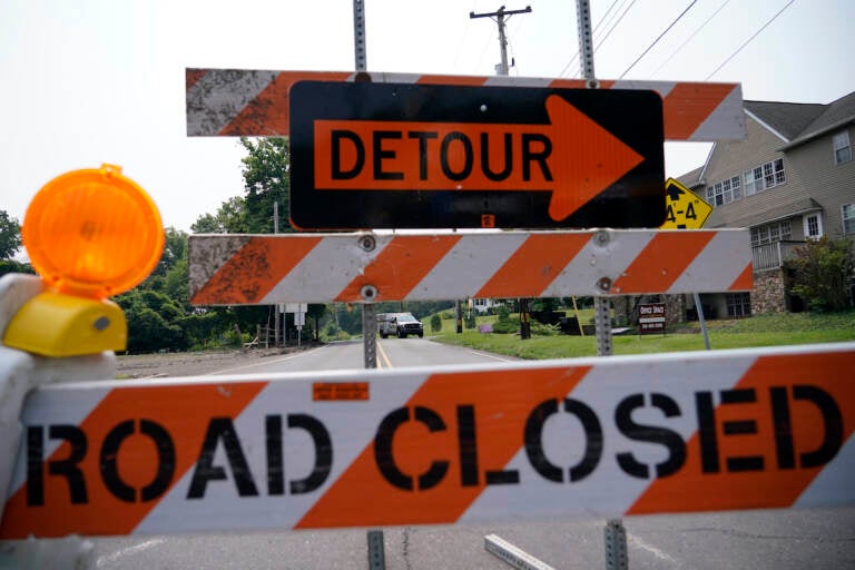 A roadblock is seen as crews search for a a pair of missing children swept away after weekend rains, Monday, July 17, 2023, in Washington Crossing, in Upper Makefield Township, Pa.
