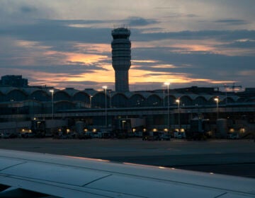 FILE - In this photo taken from the window of an American Airlines aircraft, the Air Traffic control tower at Ronald Reagan Washington National Airport is shown, June 7, 2021, in Arlington, Va. (AP Photo/Jenny Kane, File)