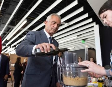 U.S. Health Secretary Robert F. Kennedy Jr. assists in a demonstration as he visits the Osher Center for Integrative Health at the University of Utah, Monday, April 7, 2025, in Salt Lake City. (AP Photo/Melissa Majchrzak)