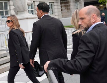 Interim US Attorney for New Jersey Alina Habba walks with men dressed in suits