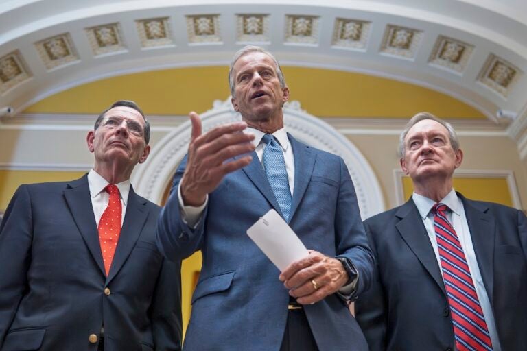 Senate Majority Leader John Thune, R-S.D., is flanked by Sen. John Barrasso, R-Wyo., the GOP whip, left, and Finance Committee Chairman Mike Crapo, R-Idaho, speaks to reporters after passage of the budget reconciliation package of President Donald Trump's signature bill of big tax breaks and spending cuts, at the Capitol in Washington, Tuesday, July 1, 2025. (AP Photo/J. Scott Applewhite)