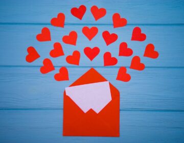 Red hearts emerging from a red envelope. (Bigstock Image)