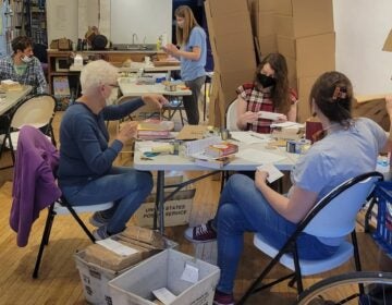 Volunteers sorting books in boxes