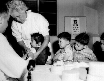Children lining up to get a vaccine shot from the doctor