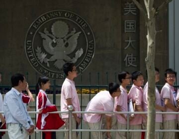 Students waiting in line in front of the Embassy