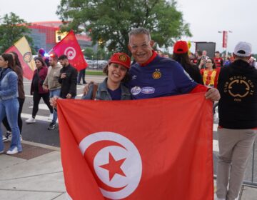Fans holding up a Tunisian flag