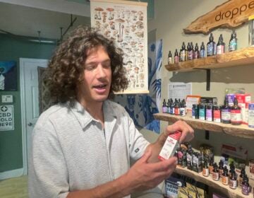 Jesse Ginefra holding up a product in the store