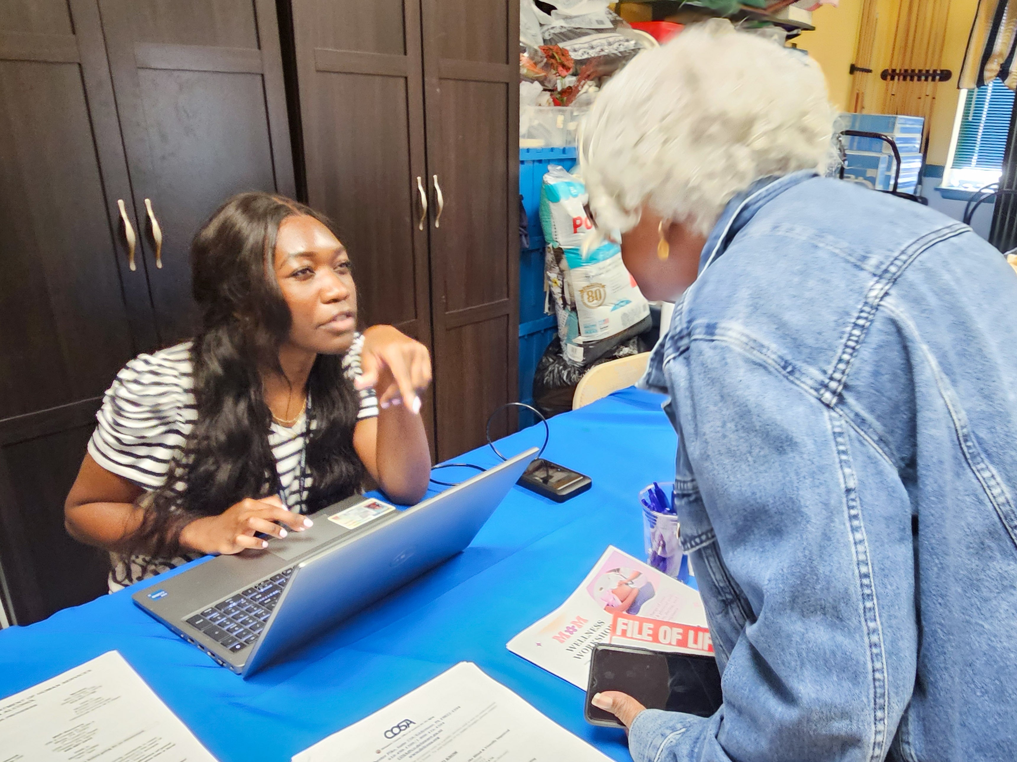 a Delaware County Health Department staff member helps a person