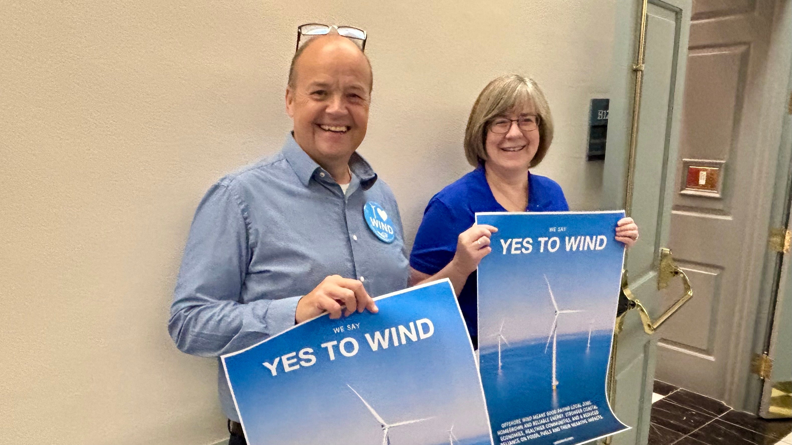 Offshore wind activists line a hallway at Legislative Hall in Dover