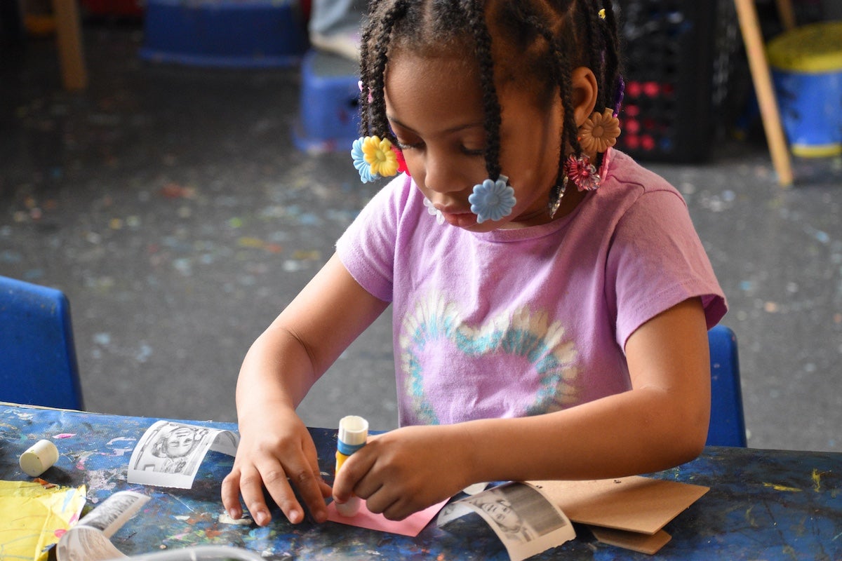 A child using stamps to paint an art project at the Settlement Music School Kaleidoscope Preschool Arts Enrichment Program in Philadelphia. (Meg Looby/Settlement Music School)