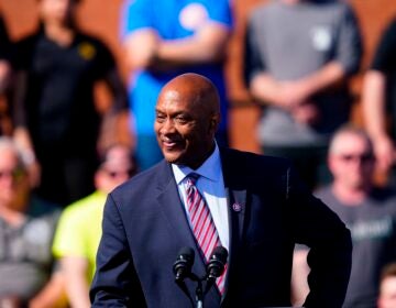 Dwight Evans speaking at a podium at an outdoor event