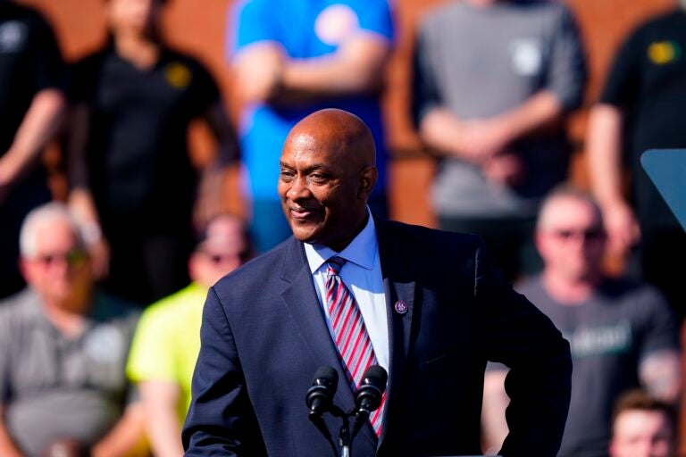 Dwight Evans speaking at a podium at an outdoor event