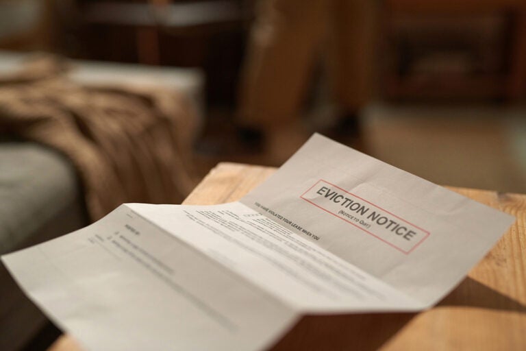 A eviction notice paper sits on a table