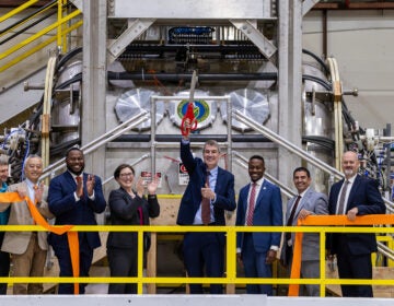 Officials at the ribbon cutting in the lab.