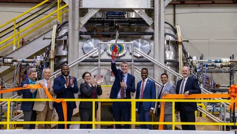 Officials at the ribbon cutting in the lab.