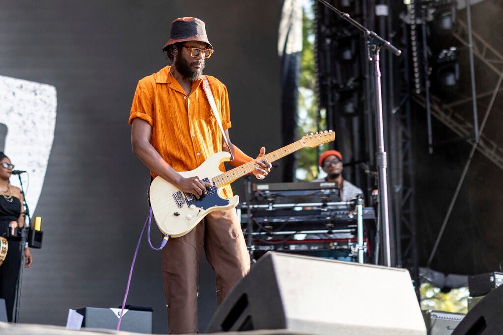 Musical artist Gary Clark Jr. plays a guitar on stage