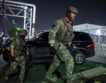 Police officers dressed in combat fatigues