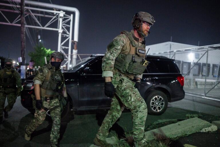 Police officers dressed in combat fatigues