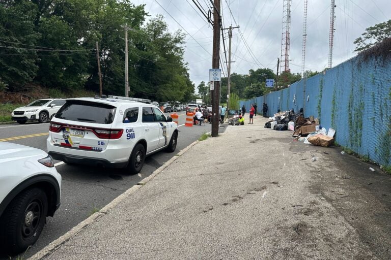 Residents drop off their trash at a temporary dump site on Domino Lane in Northwest Philadelphia during the AFSCME DC33 strike on July 2, 2025.