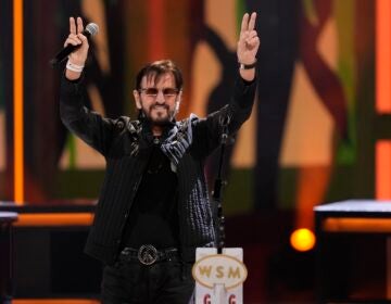 Ringo Starr holds up the peace sign