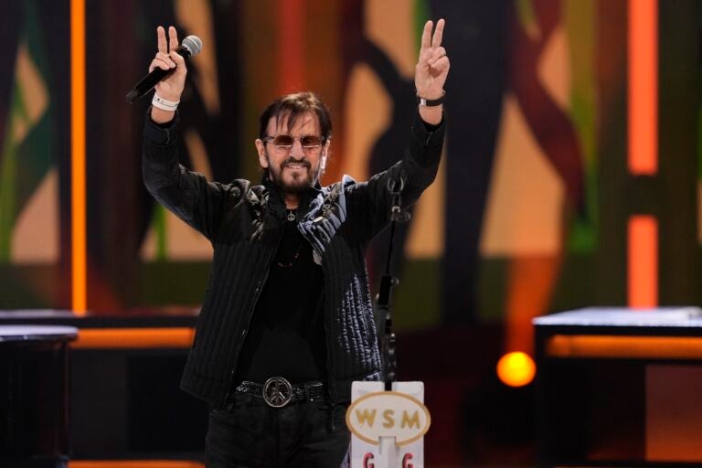 Ringo Starr holds up the peace sign