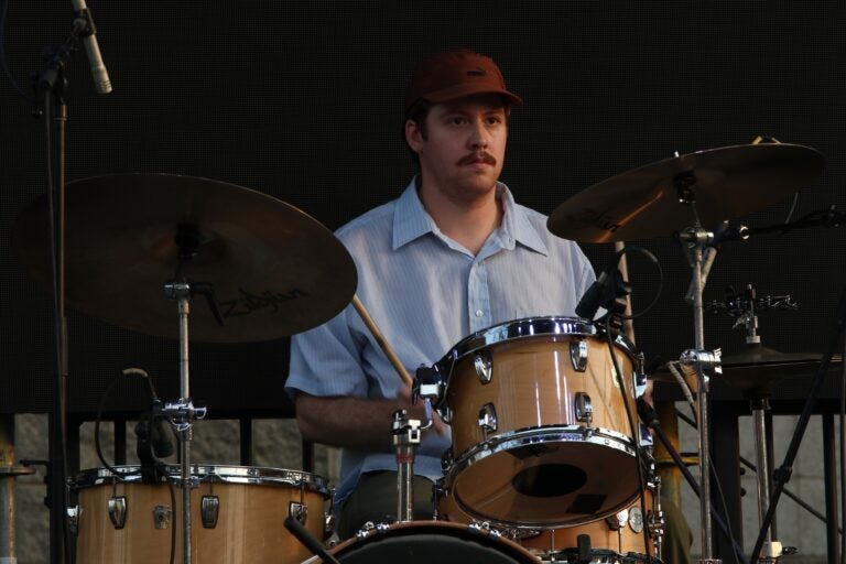 a member of the band Juuulian drumming at Spruce Street Harbor Parkng