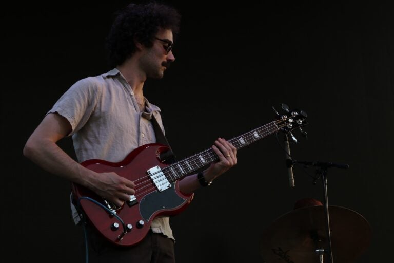 a member of the band Juuulian playing electric bass at Spruce Street Harbor Park