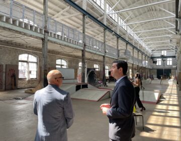 Trenton Mayor Reed Gusciora speaks with New Jersey Economic Development Authority CEO Tim Sullivan inside the Roebling Wire Works building