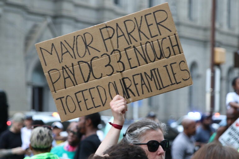 Union members and supporters marched around City Hall