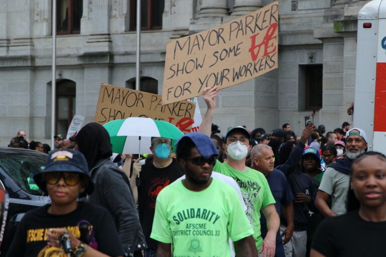 Union members and supporters marched around City Hall