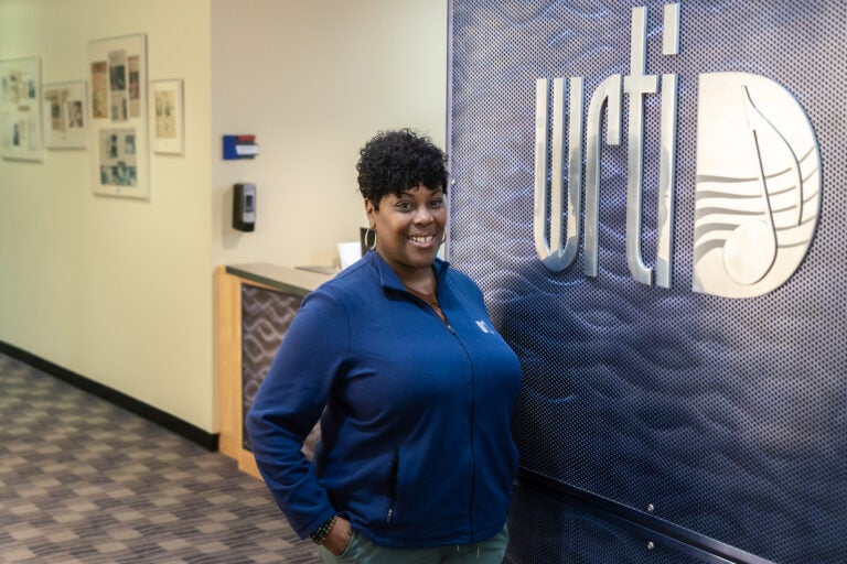 Nicole Sweeney in front of the WRTI sign at the studio